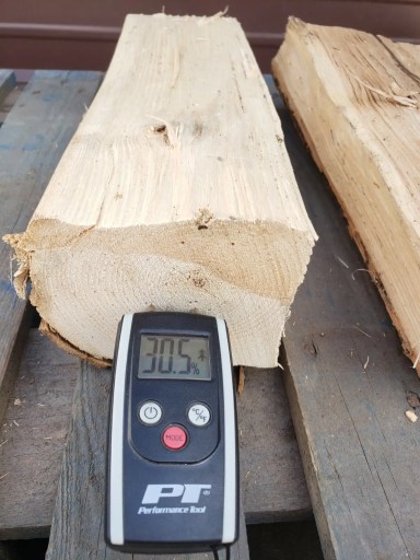 Moisture meter reading 30 percent on a freshly split ash log