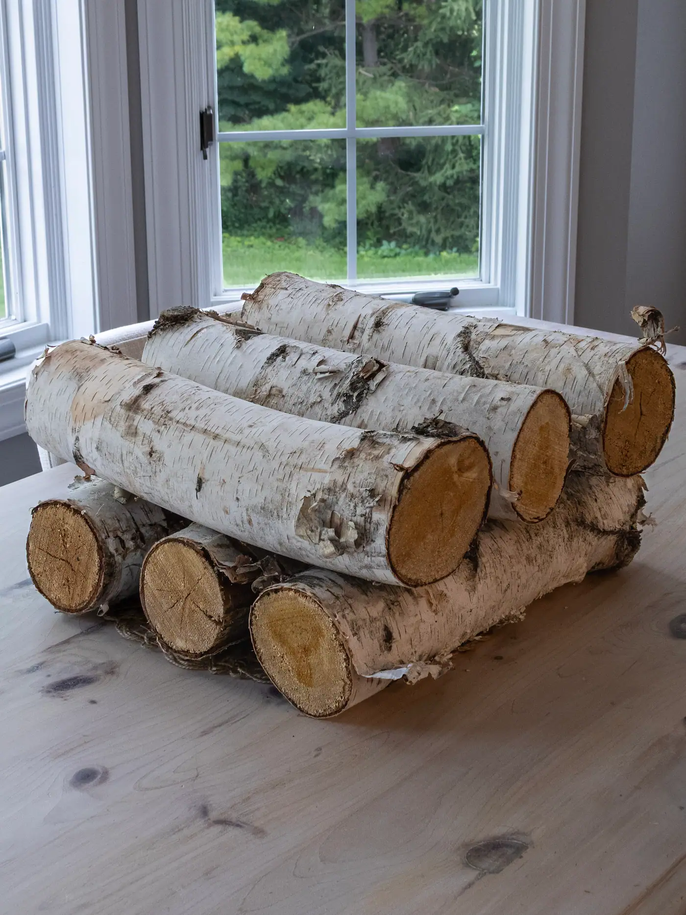 Decorative white birch logs styled as a table centerpiece display