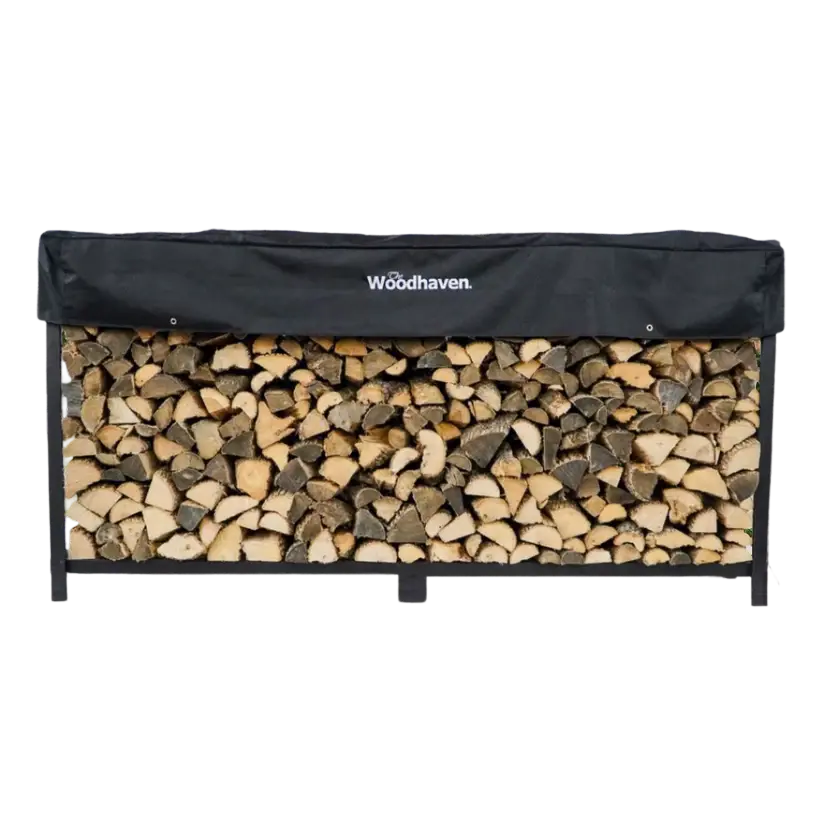 Woodhaven steel firewood rack stacked with split hardwood and waterproof cover