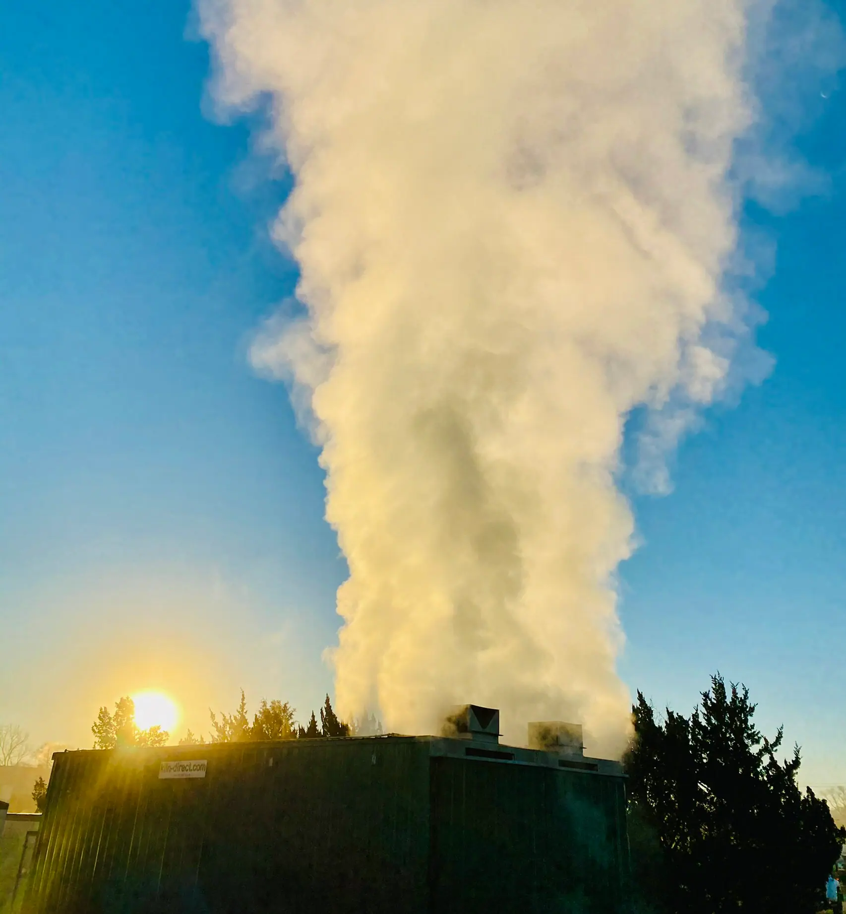 Steam and moisture exhausting from a Best Burn Firewood kiln at sunrise as water leaves the wood, New Berlin, Wisconsin