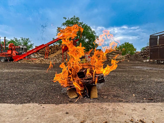 A test stack of seasoned firewood burning unassisted in the Best Burn Firewood yard, lit once and then left alone